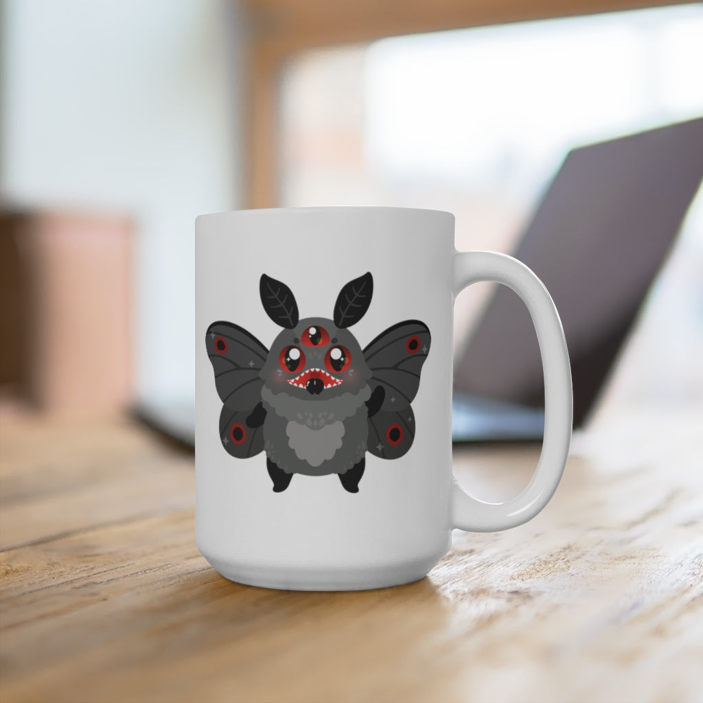 white ceramic mug with cute mothman cryptid monster with glowing red eyes and black moth wings. Reverse side test reads "mothman is real."