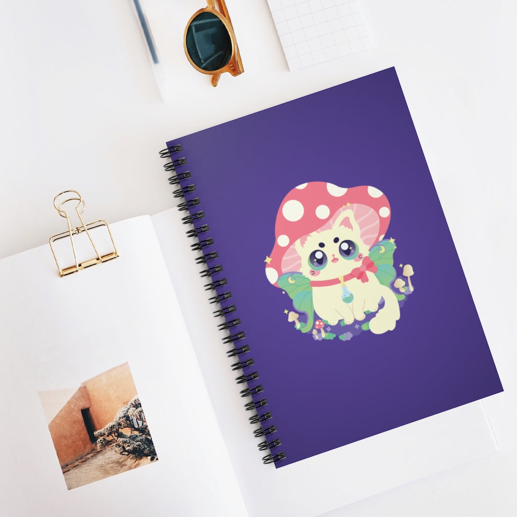 spiral notebook journal with a cottagecore cat with a mushroom hat and luna moth fairy wings sitting on a patch of moss