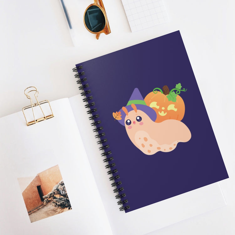 a spiral notebook journal with a kawaii cute snail wearing a witch hat and a halloween jack-o-lantern on its shell