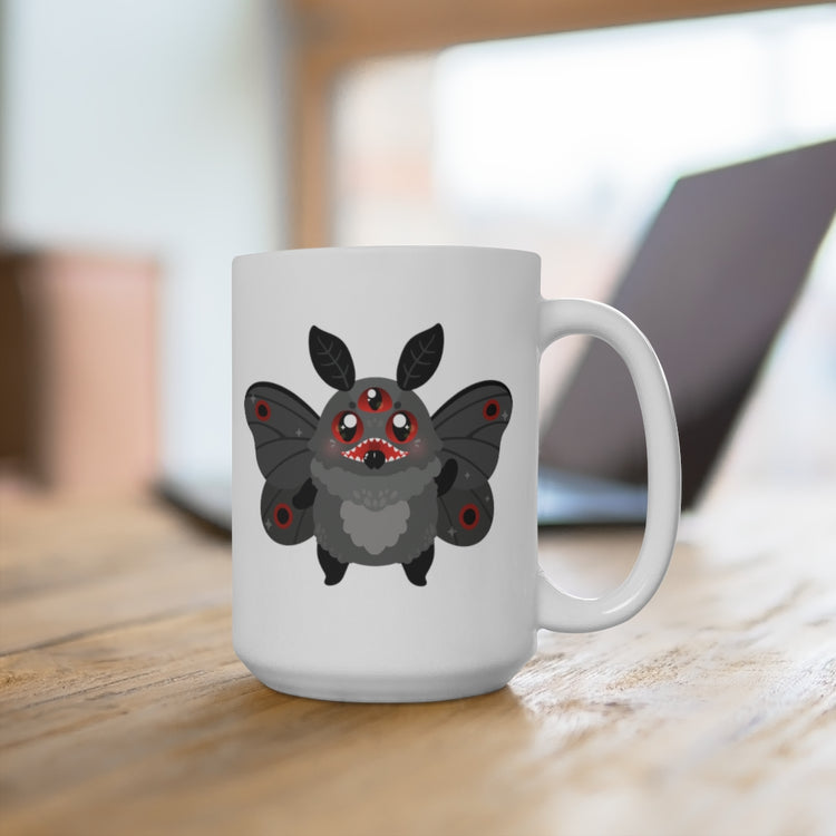 white ceramic mug with cute mothman cryptid monster with glowing red eyes and black moth wings. Reverse side test reads "mothman is real."