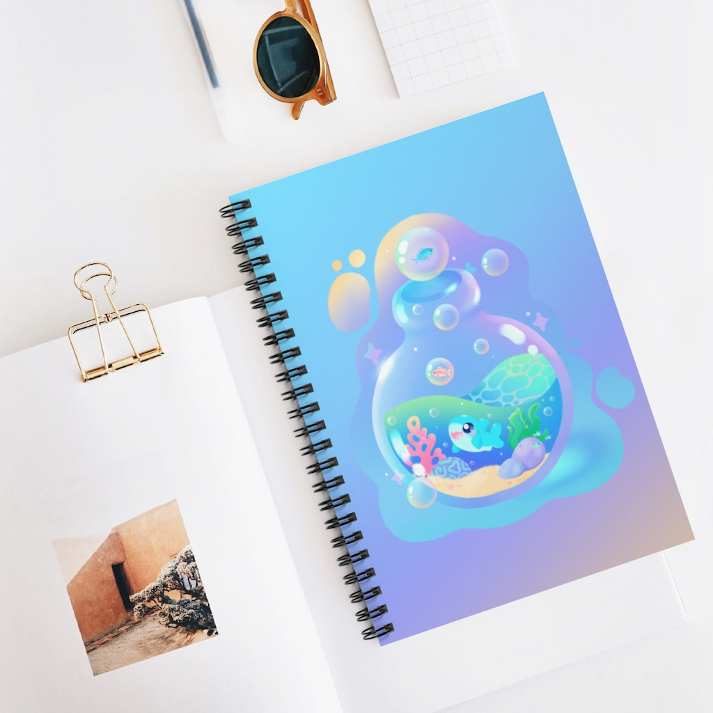 spiral notebook with a kawaii blue shark in a cute bottle with the ocean and bubbles