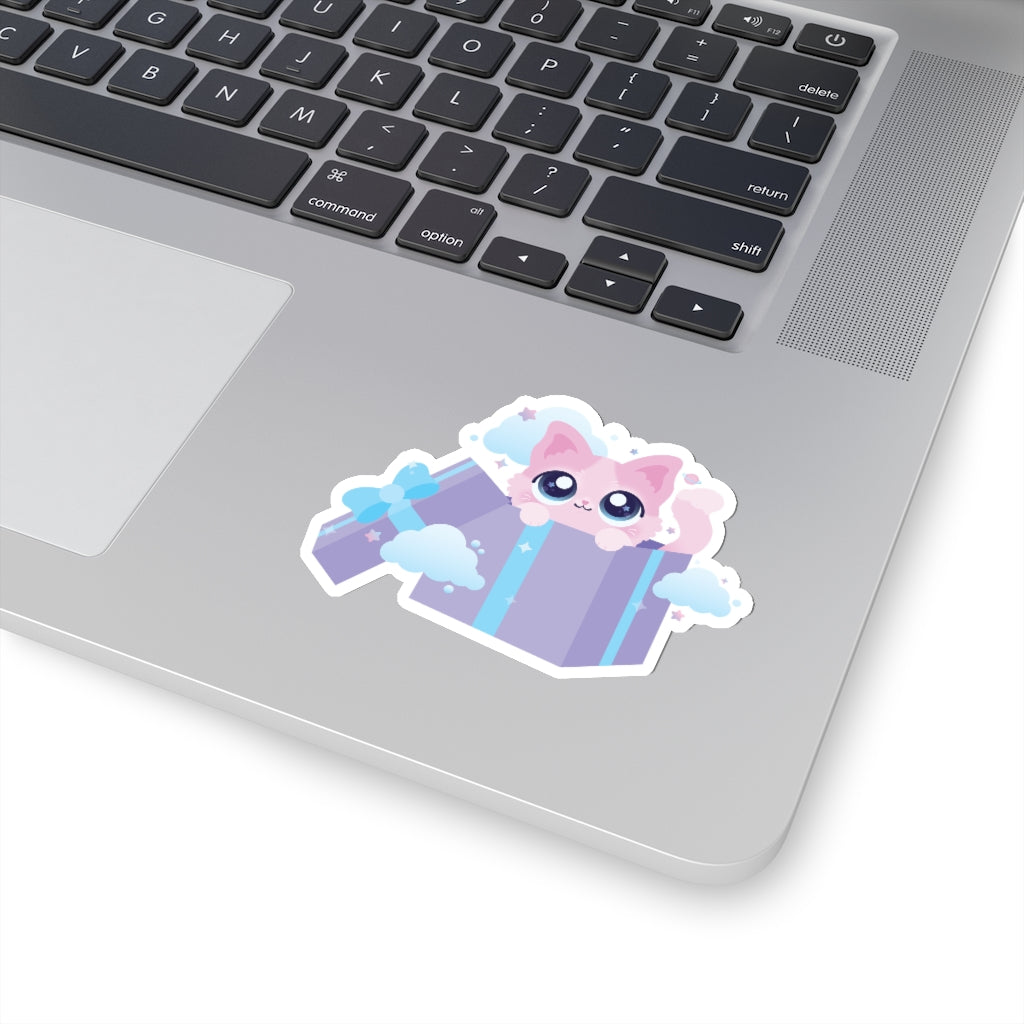sticker of a kawaii cute pink kitty cat in a purple gift box surrounded by small stars and planets