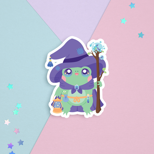 sticker of cute green frog with a purple wizard cloak and hat and a magic lantern and staff