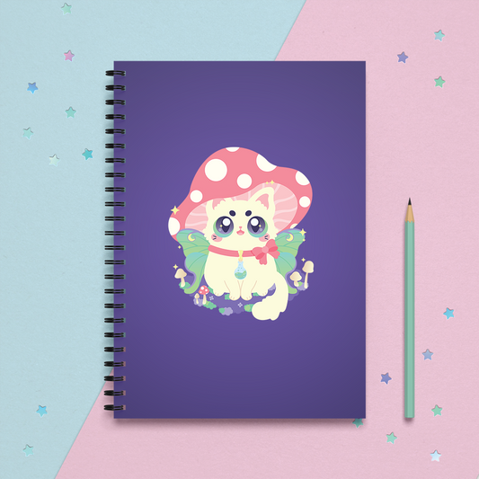 spiral notebook journal with a cottagecore cat with a mushroom hat and luna moth fairy wings sitting on a patch of moss